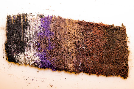 Flat lay of brush stroke. Broken shiny color eyeshadow as sample of cosmetic beauty product isolated on white backgroundの写真素材
