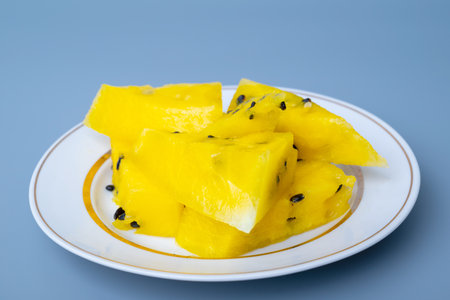 Fresh yellow watermelon slice on background, juicy delicious cut watermelon with a yellow coreの写真素材