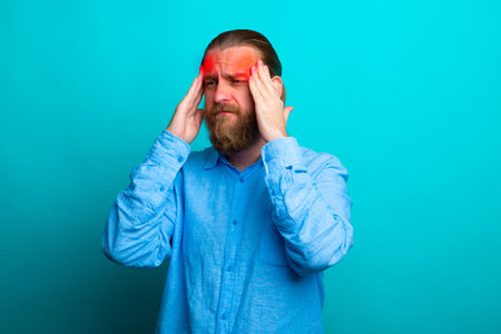 Elegant beard senior man over isolated background with hand on head for pain in head because stress. Suffering migraine.の写真素材