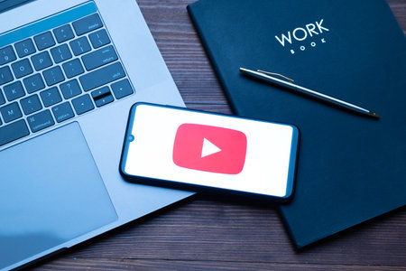 Kyoto city, Japan - July 31, 2023: Apple iPhone with Youtube logo on the screen on wooden backgroundのeditorial素材