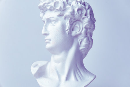 Statue. On a white isolated background. Gypsum statue of David's head. Man.の写真素材