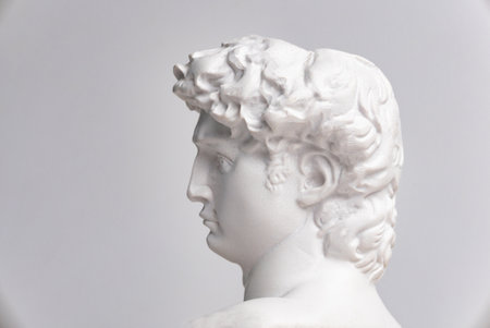 Statue. On a white isolated background. Gypsum statue of David's head. Man.の写真素材