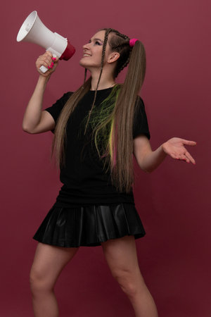 woman take loudspeaker and show something to youの写真素材