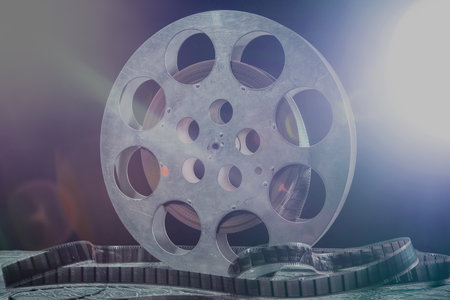 35 mm film reel with dramatic lighting on a dark backgroundの写真素材