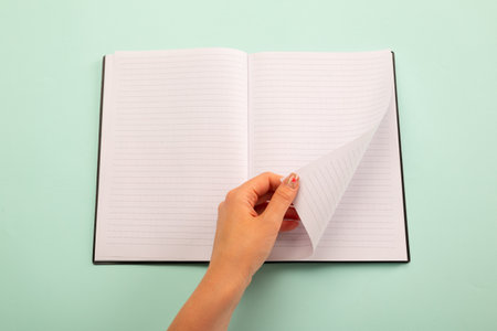 A female hands hold(grip) a vintage(old) book(note, diary) spread and through the pages of a book on...