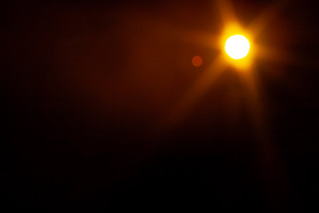 Sun flare on the black backgroundの写真素材