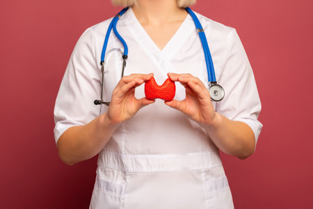 Female doctor is holding anatomical model of thyroid gland. Help and care concept
