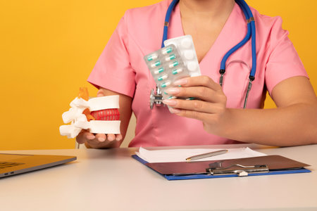 Doctor holds Anatomical lumbar disc herniation model and pills close-up. Protection, treatment, prevention concept. Intervertebral hernia treatmentの写真素材