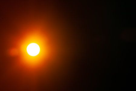 Sun flare on the black backgroundの写真素材