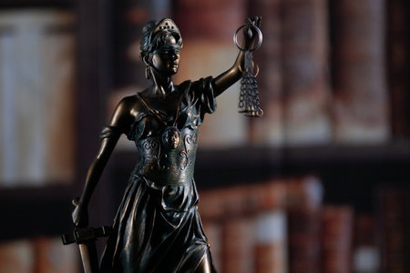 Law and wisdom. Statue of Lady Justice near shelves with books. High quality photo