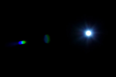 Sun flare on the black backgroundの写真素材