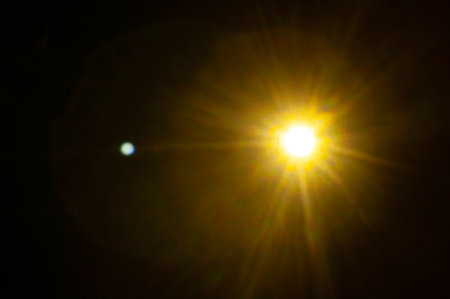 Sun flare on the black backgroundの写真素材