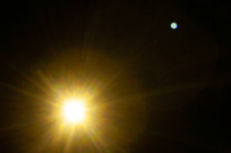 Sun flare on the black backgroundの写真素材