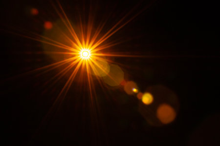 Sun flare on the black backgroundの写真素材