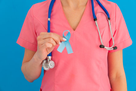 Doctor hands holding blue ribbon, Colorectal Cancer Awareness - Imageの写真素材