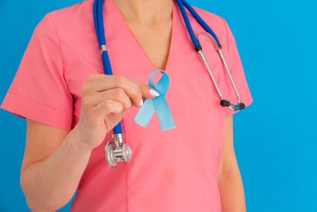 Doctor hands holding blue ribbon, Colorectal Cancer Awareness - Imageの写真素材