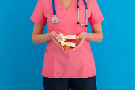 Anatomical lumbar disc herniation model doctor hold in hands in medical clinic. Intervertebral...