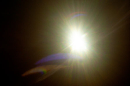 Sun flare on the black backgroundの写真素材