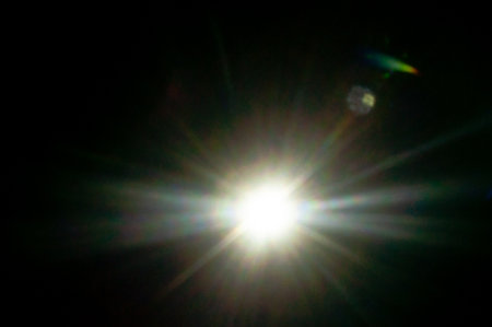 Sun flare on the black backgroundの写真素材