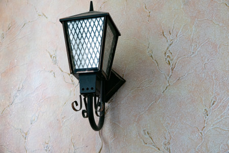 Iron Street Lantern on the wall. Streetlights shine. High quality photoの写真素材