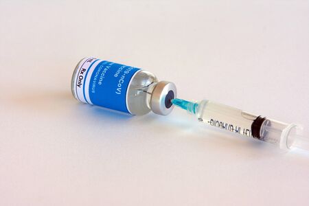 The needle sticks through the sterile membrane into the vial vaccine isolated on white background.