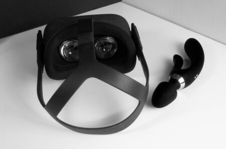 VR glasses VR helmet next to a black dildo vibrator. The concept of virtual 3D porn and the future of the porn industry. Female pleasureの写真素材