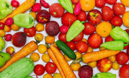 Washed fruits and vegetables with water drops top view on a white backgroundの写真素材