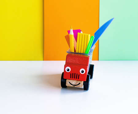 A set of school supplies and stationery for primary school children and kindergartens copy space. Delivery and fun workplace concept. Organizer toy carの写真素材