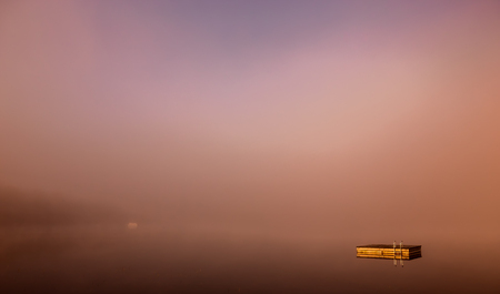 view of a boat dock the Lac-Superieur, misty morning with fog, in Laurentides, Mont-tremblant, Quebec, Canadaの写真素材