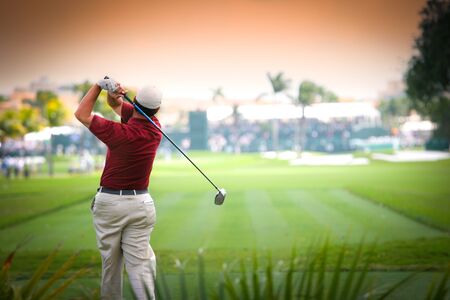 man golfer in action on a golf courseの写真素材