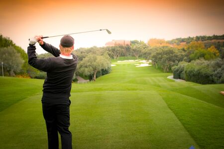 man golfer in action on a golf courseの写真素材