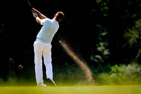 man golfer in action on a golf courseの写真素材