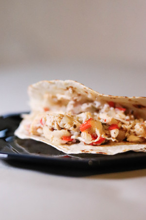 Close up of a taco on a black plateの写真素材