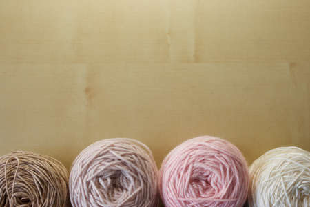 Balls of wool cotton silk yarn set on copy space wood background on topの写真素材