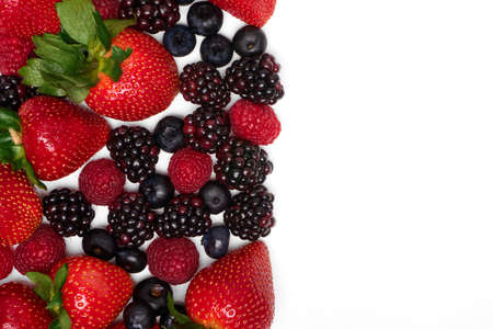 blackberries and strawberries on a white background with side copy space. ideal for advertising, posters and brochures.の写真素材