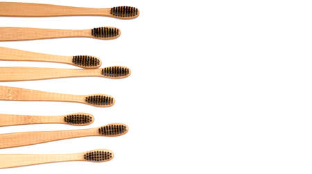 Bamboo toothbrushes formed horizontally on white background. environmentally friendly biodegradable...