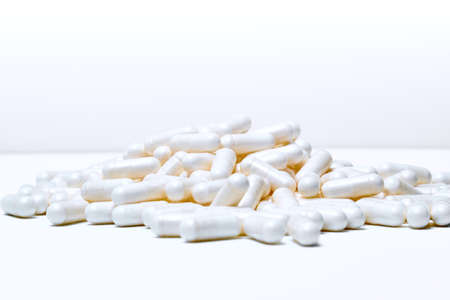 marine magnesium capsules on white background with advertising copy space.
