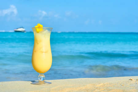 piÃ±a colada on the sand on the beaches of Isla Mujeres, Mexico. sea background out of focus. advertising copy spaceの写真素材