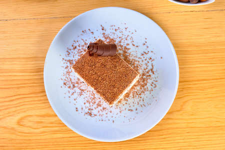 italian semifreddo (viennetta) dessert with vanilla cream and chocolate bars, decorated with...