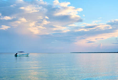 boat on the beach shore of holbox, mexico.Mayan Riviera landscape with a spectacular sky full of...