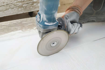 marble cutting with the Winkelschleifer and specially cut wild is carried out by a workerの写真素材