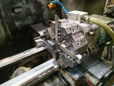 old cnc lathe with interchangeable cutters and poured cooling white emulsionの写真素材