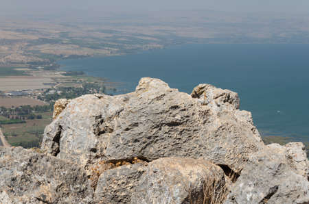 landscape in the mountains on a sunny day with a view from the mountain settlement of people and the lakeの写真素材