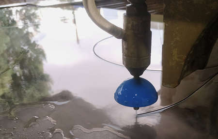 decorative cutting of mirrors with water and sand on a CNC machine of complex shapesの写真素材