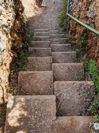 ancient stone staircase with large steps in the mountains