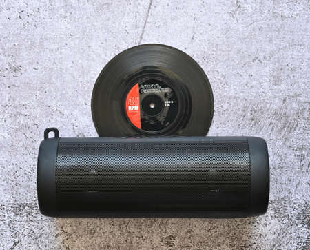 on the light marble is a vinyl record with a   speaker