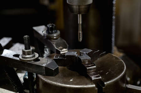 Clamp the tapping tap in the chuck of the drilling machine in a stationary vertical positionの写真素材