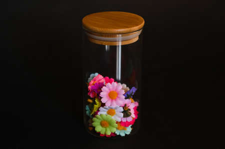 decorative elements for various festive events are placed in glass jars on a light backgroundの写真素材