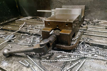 vise on a metal workbench around metal shavings close-up