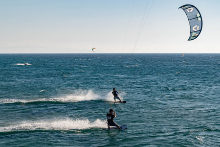 Nahariya, Israel - November 5, 2021: Galei Galil Beach. Aman is kitesurfing on the sea in sunny...